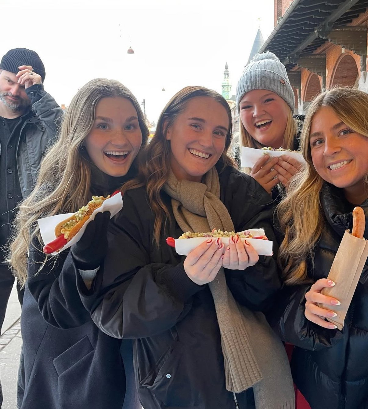 ILP volunteers eating Danish Hotdog