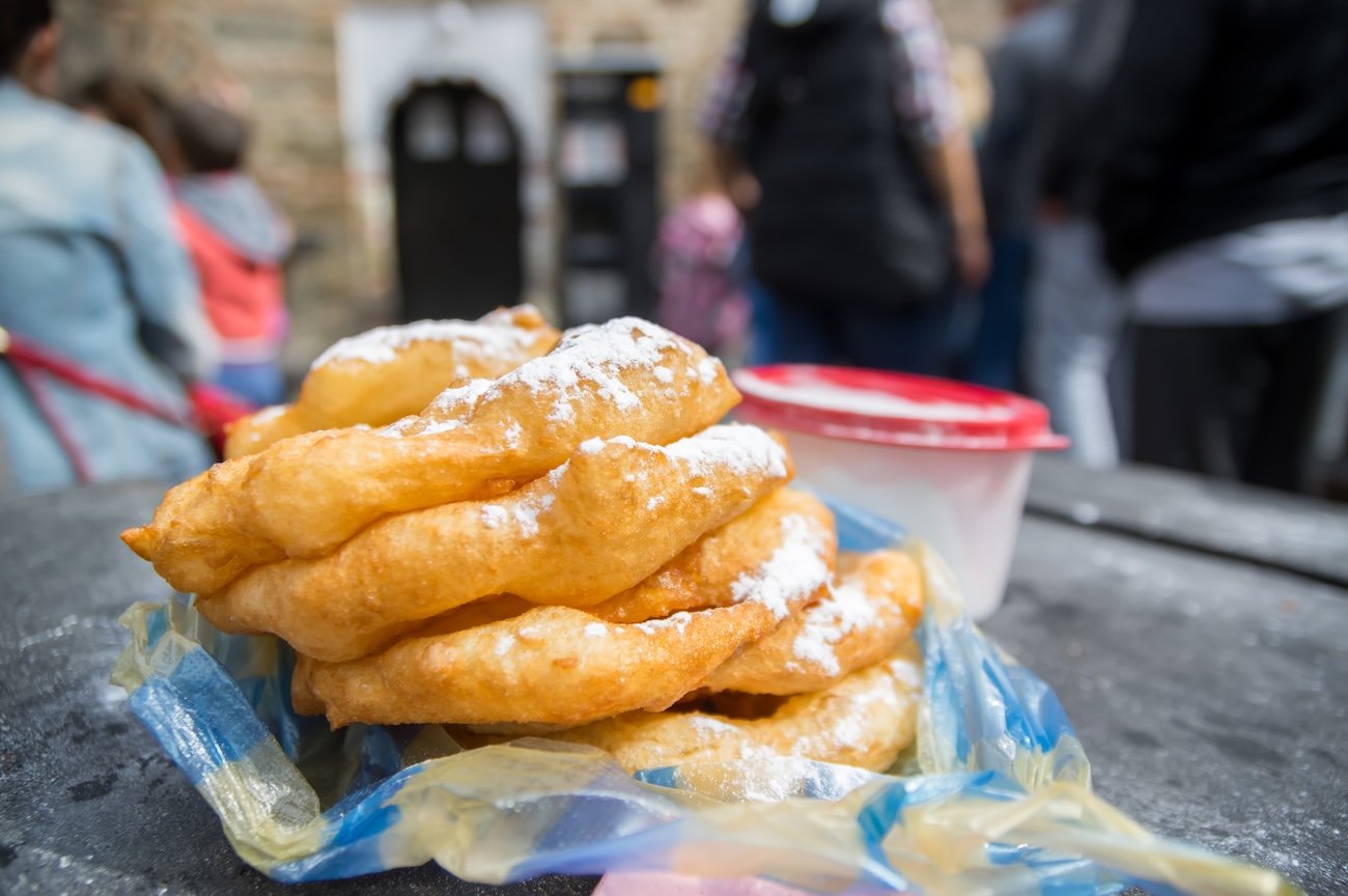 Mekitsi, Mekici, Mekitzi - traditional Bulgarian breakfast dish made of fried bread dough, with sugar and Bulgarian yogurt (kiselo mliako)AdobeStock_361559412